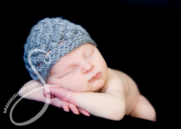 Newborn gray hat sleeping on tummy