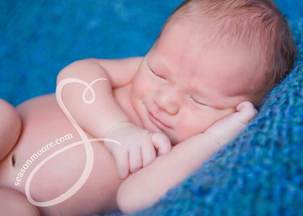 Smiling Newborn on Blue