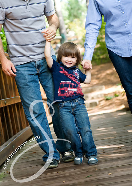 little boy swing with mom dad