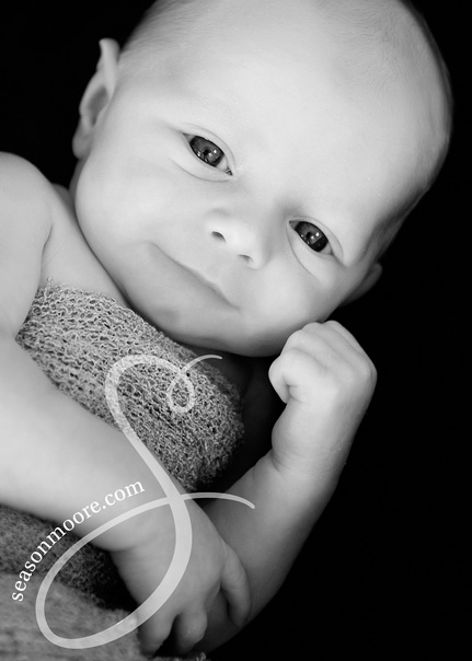 newborn boy smiling black and white