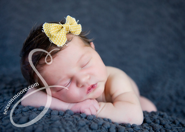 newborn with yellow bow