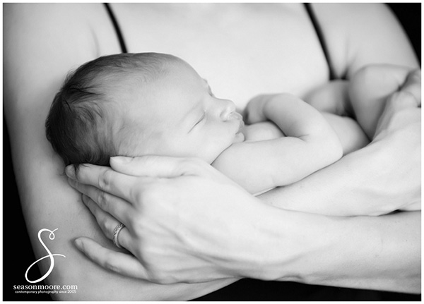 black and white newborn in moms arms 